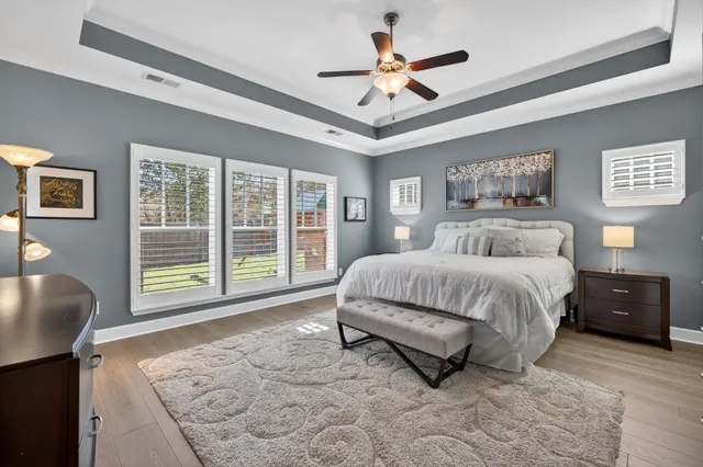 a spacious bedroom with a bed and a chandelier