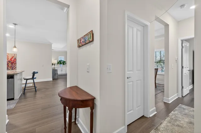 a large room with wooden floor a furniture and a large window
