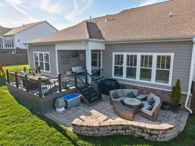 a view of a house with backyard and sitting area