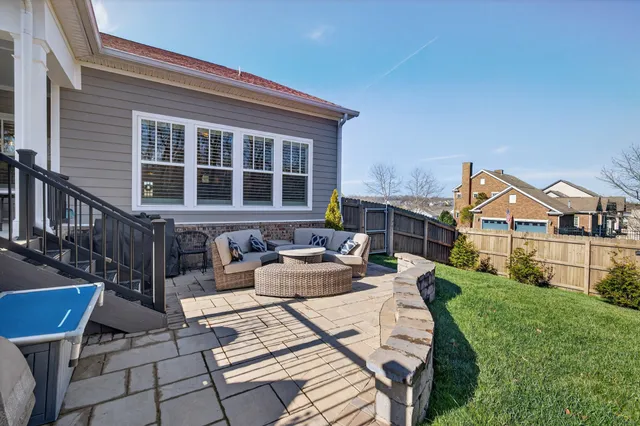 a view of a house with a yard and sitting area