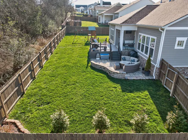 a view of a house with a yard and sitting area