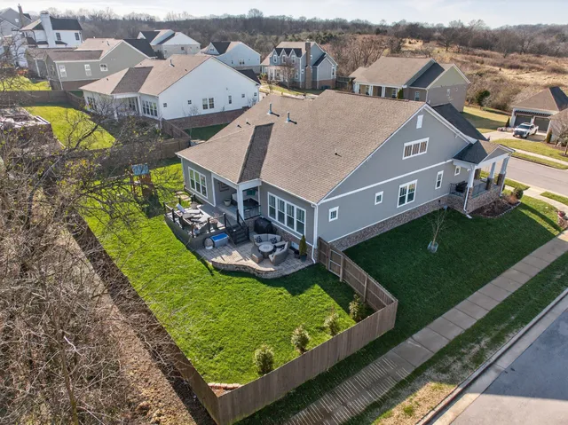 an aerial view of a house with a big yard
