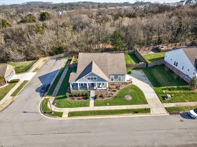 an aerial view of a house with a big yard