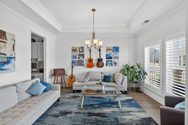a living room with furniture and a chandelier