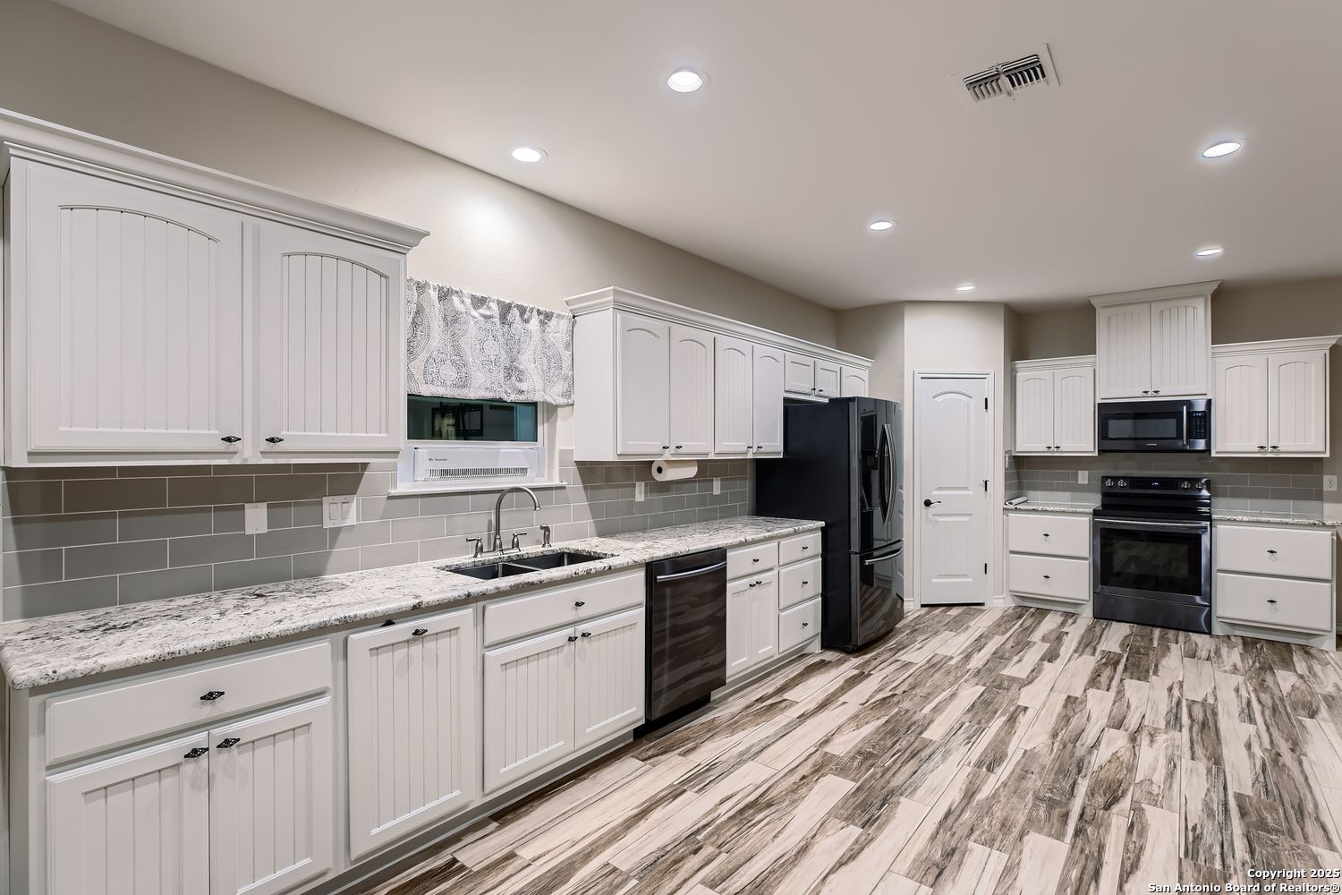 3963 Summit Hurst New Braunfels, TX 78132 - Photo 11 of 28 a kitchen with granite countertop a refrigerator stove top oven and sink