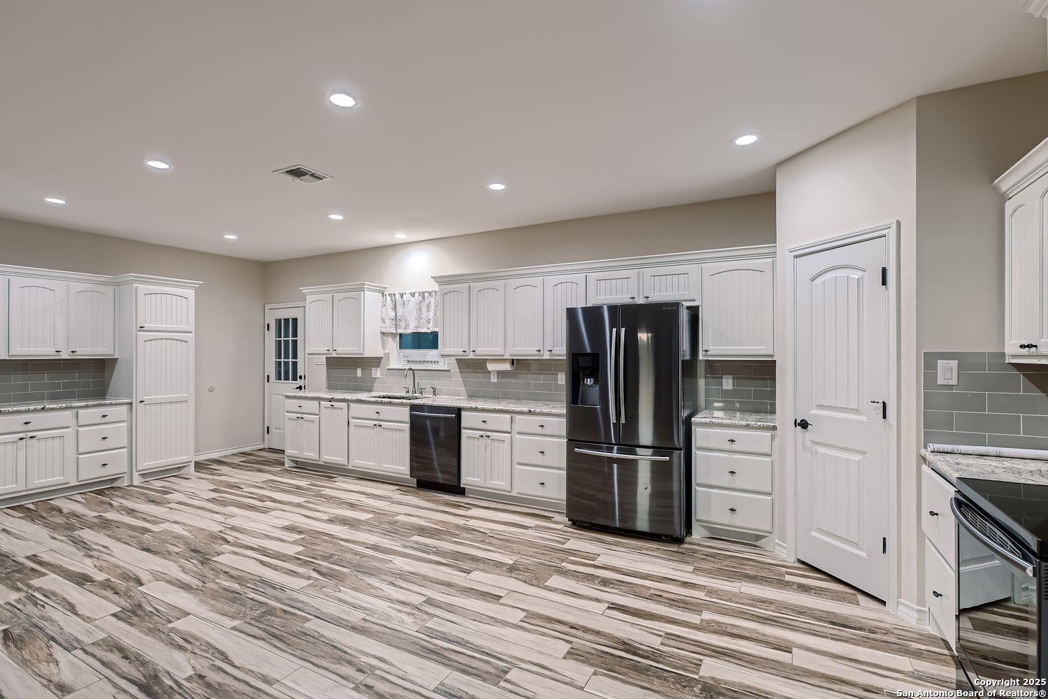 3963 Summit Hurst New Braunfels, TX 78132 - Photo 12 of 28 a kitchen with stainless steel appliances a refrigerator and a stove top oven