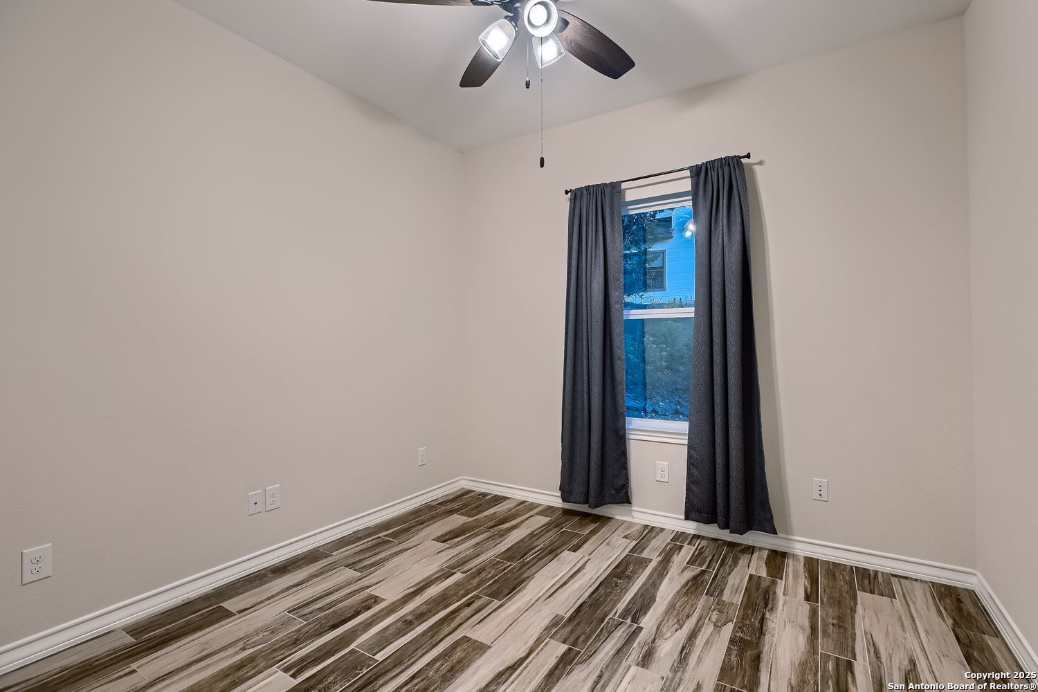 3963 Summit Hurst New Braunfels, TX 78132 - Photo 19 of 28 a view of a room with wooden floor and fan