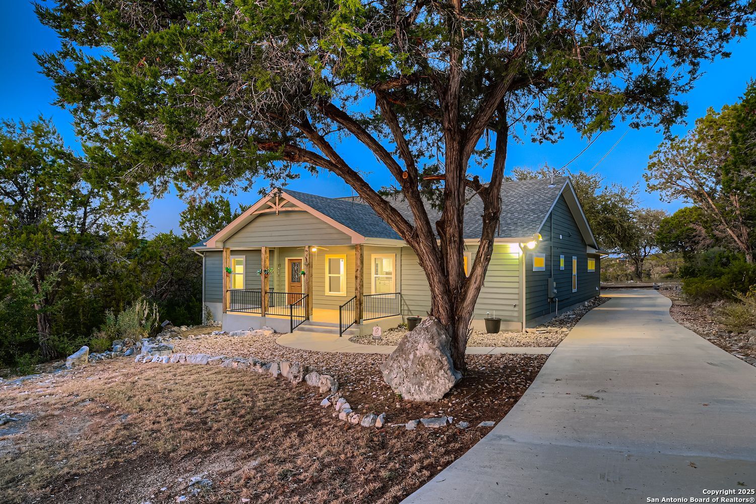 3963 Summit Hurst New Braunfels, TX 78132 - Photo 2 of 28 a front view of a house with a yard and garage