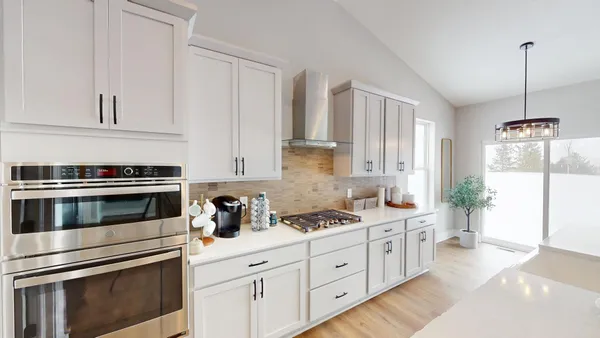 a kitchen with stainless steel appliances white cabinets and a stove
