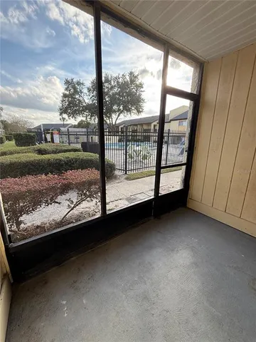 a view of a room with wooden floor and a fireplace