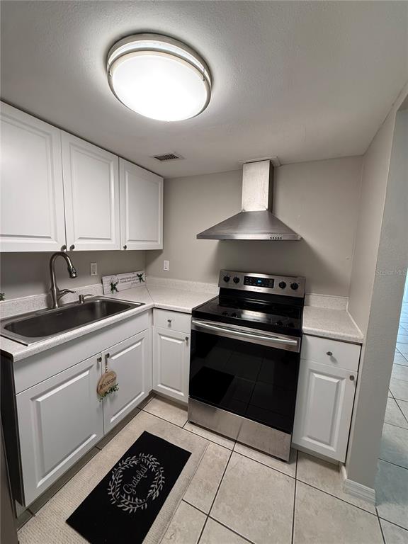 942 Lake Destiny Road, Unit B Altamonte Springs, FL 32714 - Photo 5 of 14 a kitchen with granite countertop a stove sink and cabinets