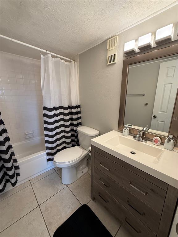 942 Lake Destiny Road, Unit B Altamonte Springs, FL 32714 - Photo 9 of 14 a bathroom with a sink a toilet a mirror and shower curtain