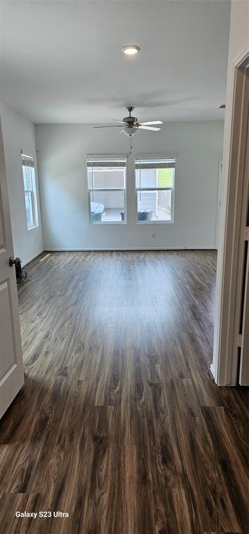 1401 Linwood Street Leander, TX 78641 - Photo 15 of 39 Empty room with plenty of natural light, dark wood-style flooring, a ceiling fan, and recessed lighting