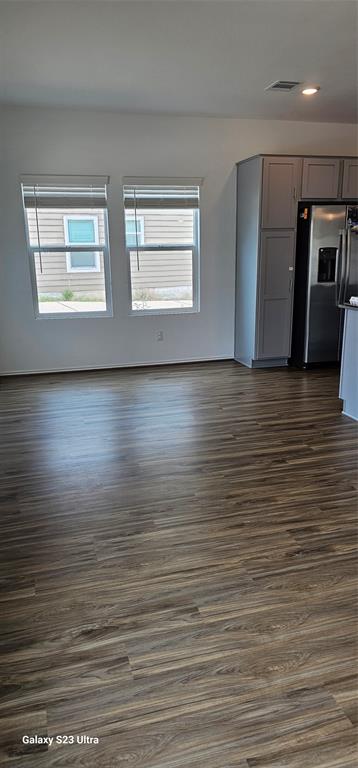 1401 Linwood Street Leander, TX 78641 - Photo 17 of 39 Unfurnished living room featuring dark wood finished floors and baseboards