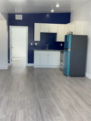 a kitchen with stainless steel appliances a refrigerator and a stove top oven