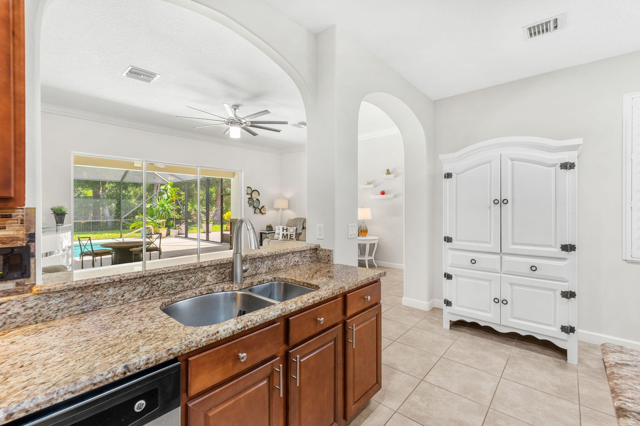 7657 Fieldstone Ranch Square Vero Beach, FL 32967 - Photo 22 of 52 a kitchen with granite countertop a sink and a window