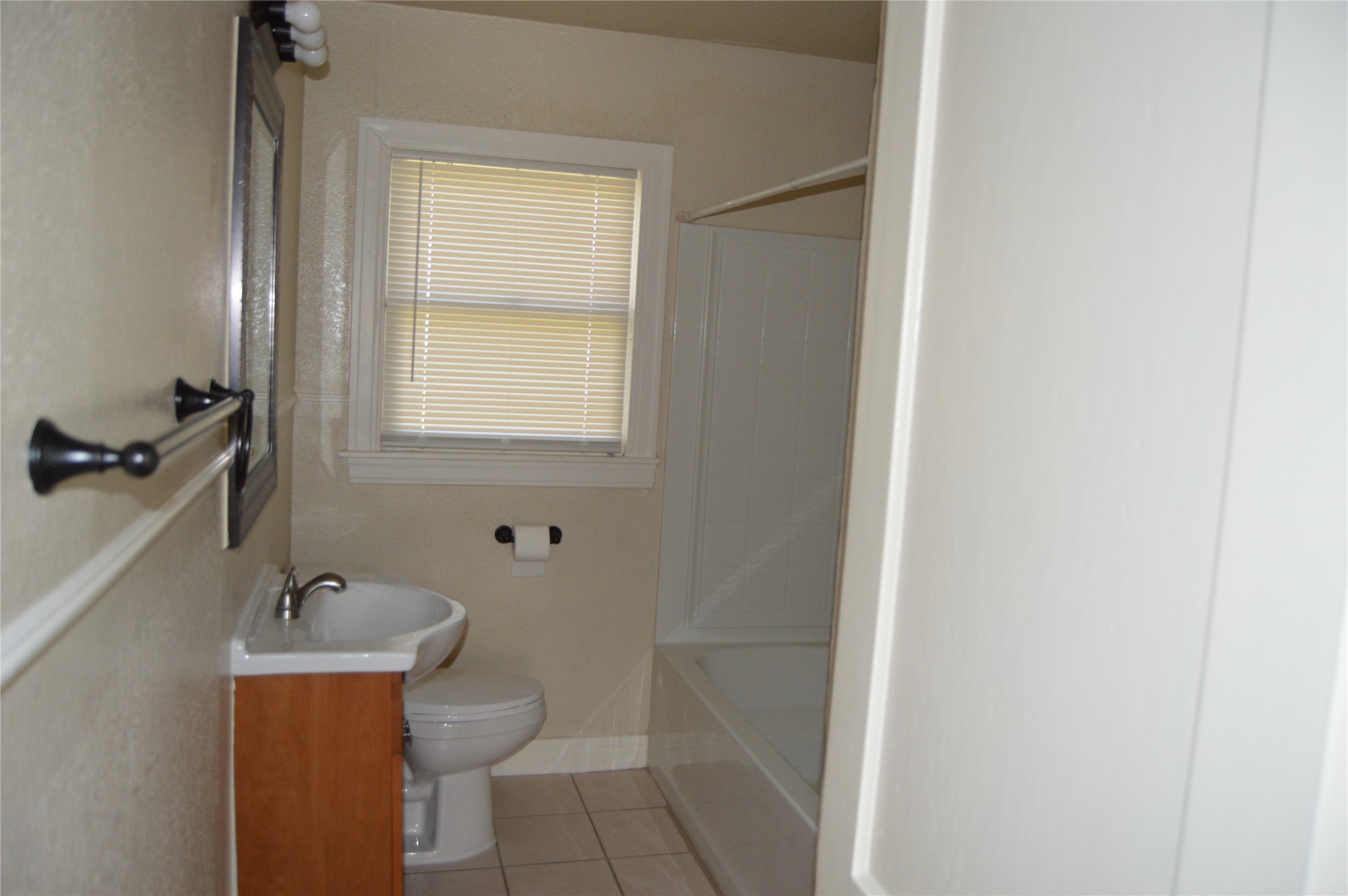 2616 East 3rd Street Austin, TX 78702 - Photo 6 of 11 a bathroom with a toilet a sink and mirror