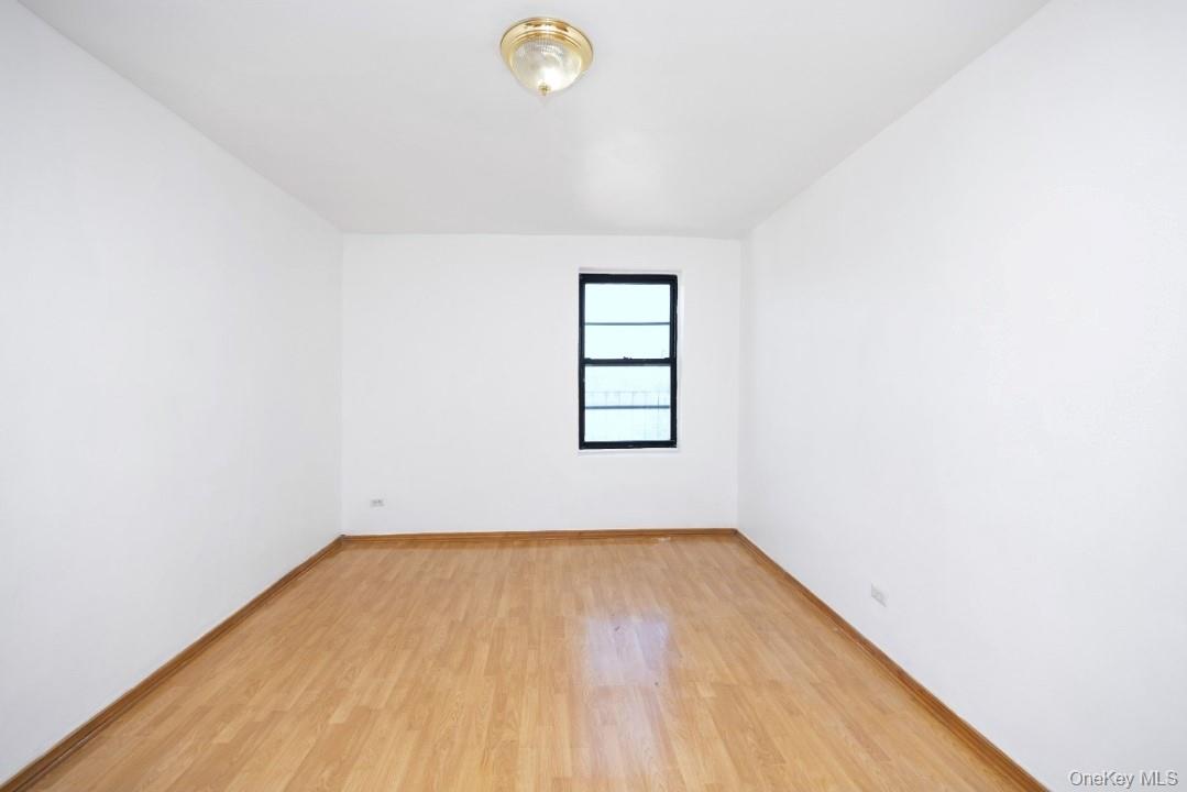 44-25 Macnish Street, Unit 6D Queens, NY 11373 - Photo 11 of 20 a view of a room with wooden floor and window
