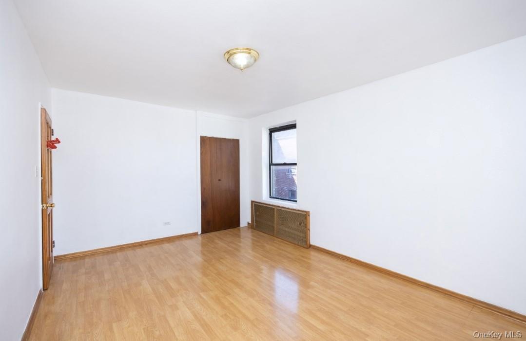 44-25 Macnish Street, Unit 6D Queens, NY 11373 - Photo 12 of 20 a view of empty room with wooden floor