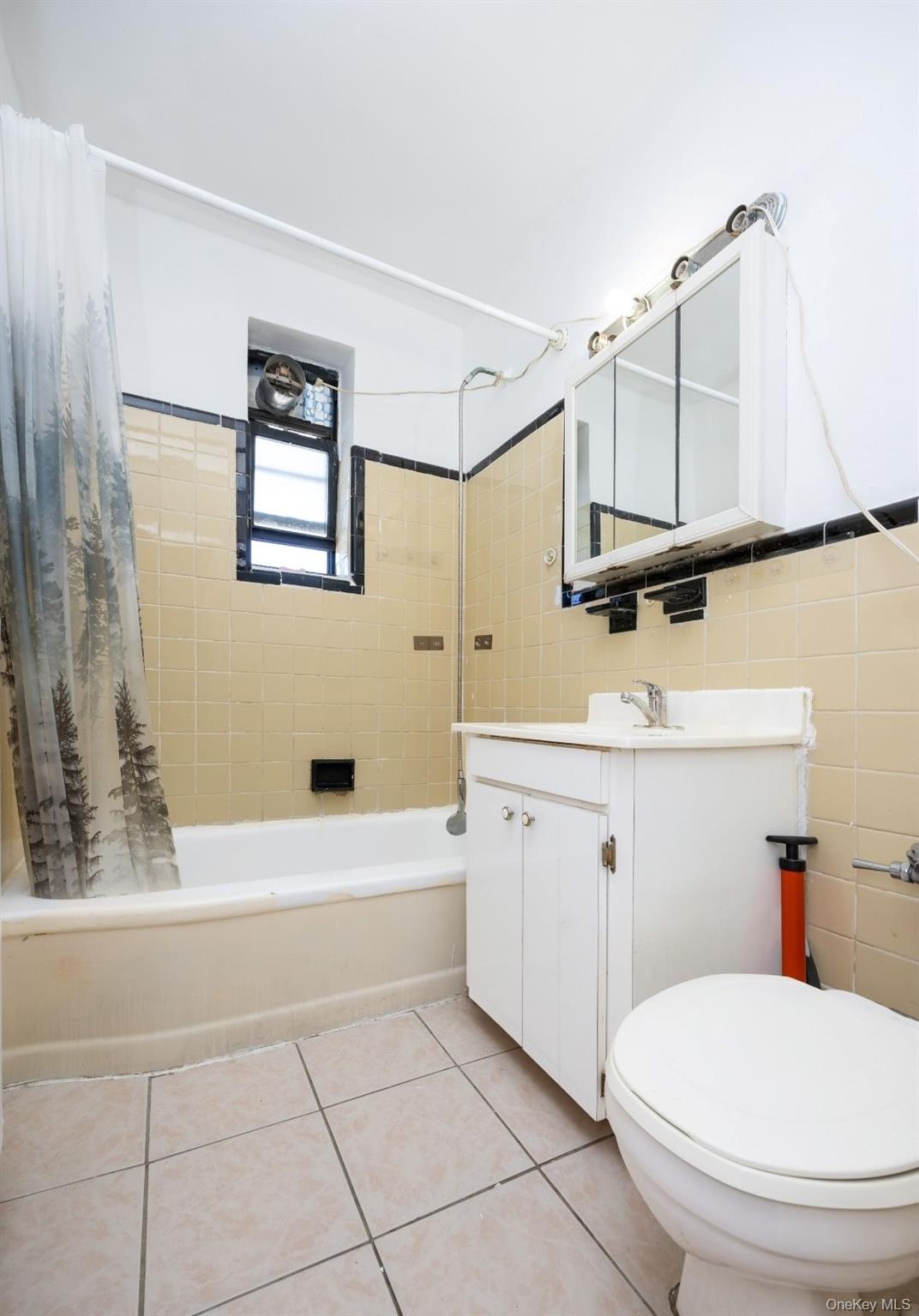 44-25 Macnish Street, Unit 6D Queens, NY 11373 - Photo 14 of 20 a bathroom with a sink a toilet and bathtub