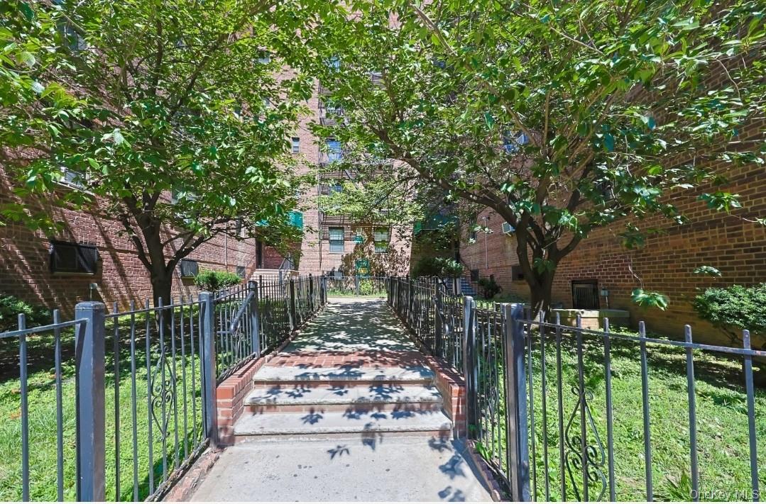 44-25 Macnish Street, Unit 6D Queens, NY 11373 - Photo 17 of 20 a front view of a house with a garden