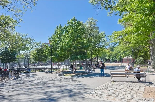 a wooden bench sitting in the middle of a park