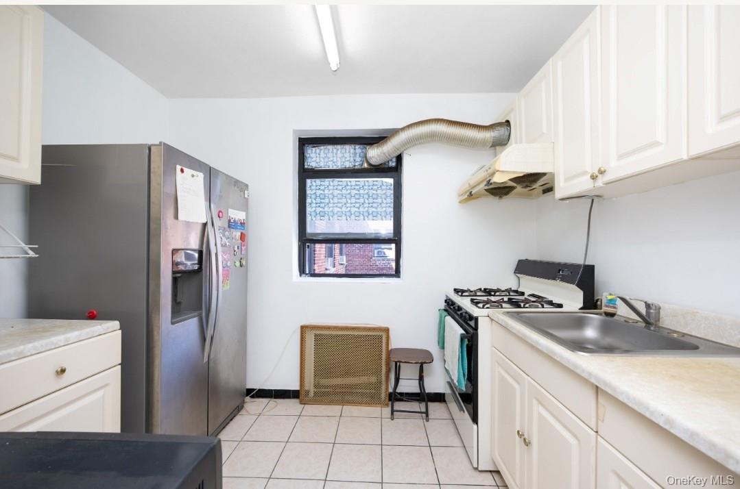 44-25 Macnish Street, Unit 6D Queens, NY 11373 - Photo 7 of 20 a kitchen with stainless steel appliances granite countertop a refrigerator and a stove