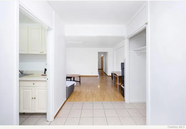 a open hall with white cabinets