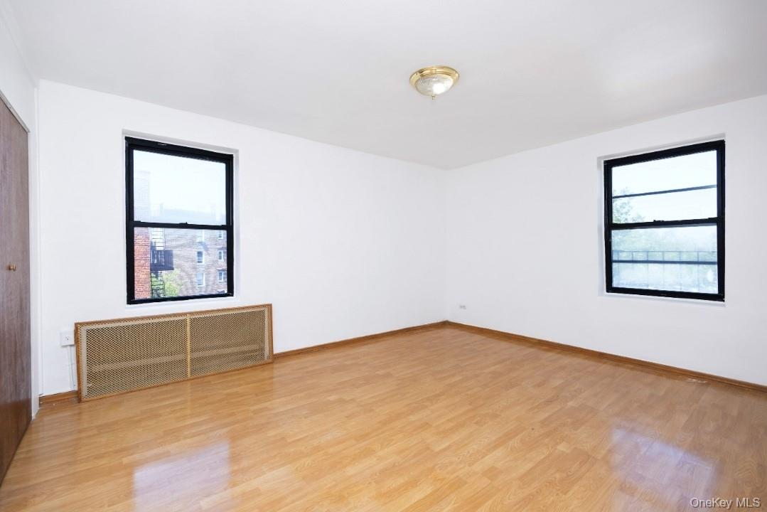 44-25 Macnish Street, Unit 6D Queens, NY 11373 - Photo 10 of 20 an empty room with window and cabinet