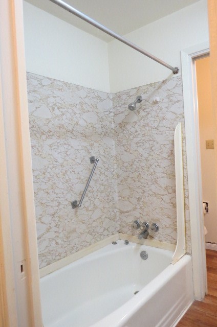1917 20th Street, Unit 3 Huntsville, TX 77340 - Photo 11 of 18 a bathroom with a bathtub and a shower