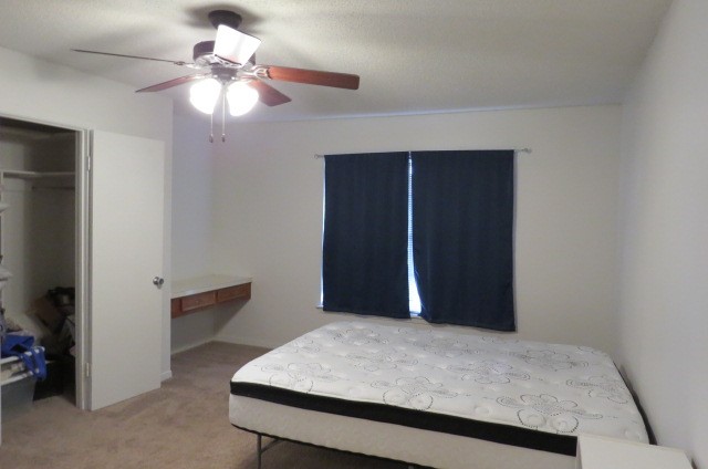 1917 20th Street, Unit 3 Huntsville, TX 77340 - Photo 13 of 18 a bedroom with a bed and a chandelier