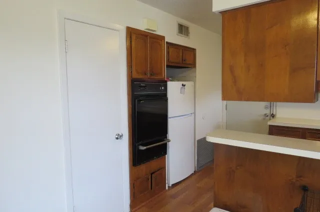 a kitchen with stainless steel appliances a refrigerator and a stove top oven