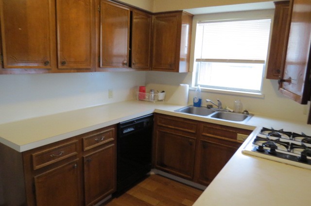 1917 20th Street, Unit 3 Huntsville, TX 77340 - Photo 3 of 18 a kitchen with stainless steel appliances granite countertop a sink stove and cabinets