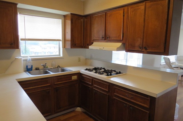 1917 20th Street, Unit 3 Huntsville, TX 77340 - Photo 4 of 18 a kitchen with a sink a stove and cabinets