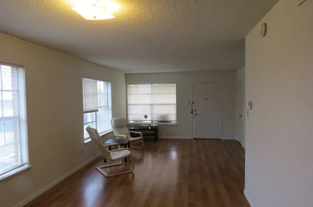 a room with wooden floor and a window