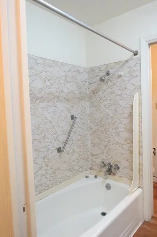 a bathroom with a bathtub and a shower