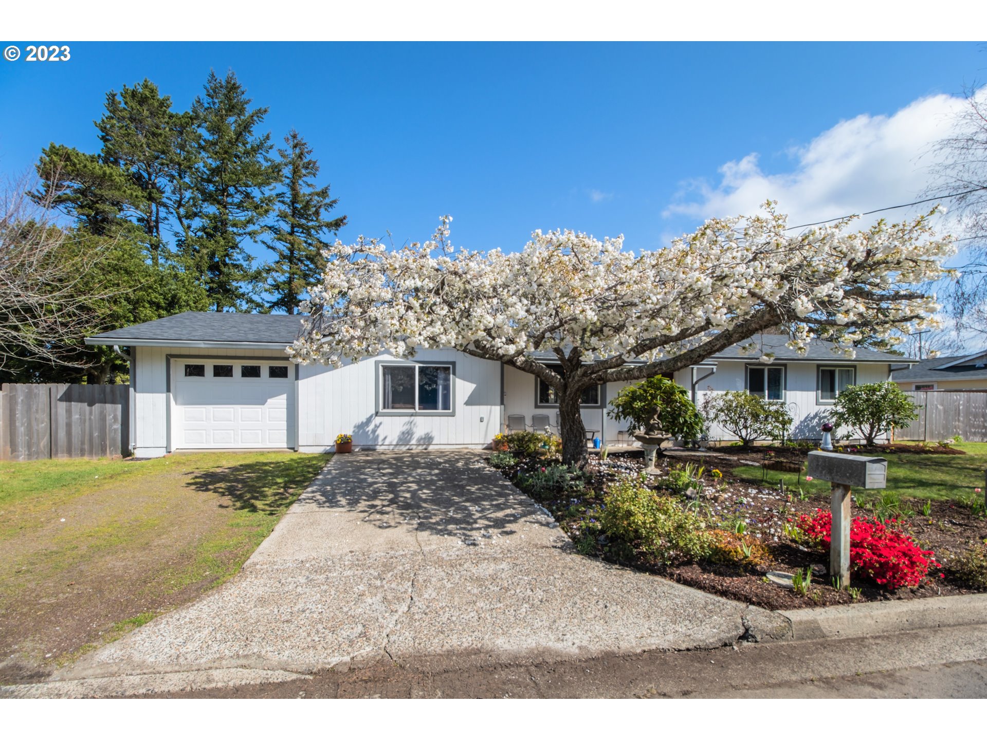 2035 16th Street Florence, OR 97439 - Photo 1 of 30 a front view of a house with a yard