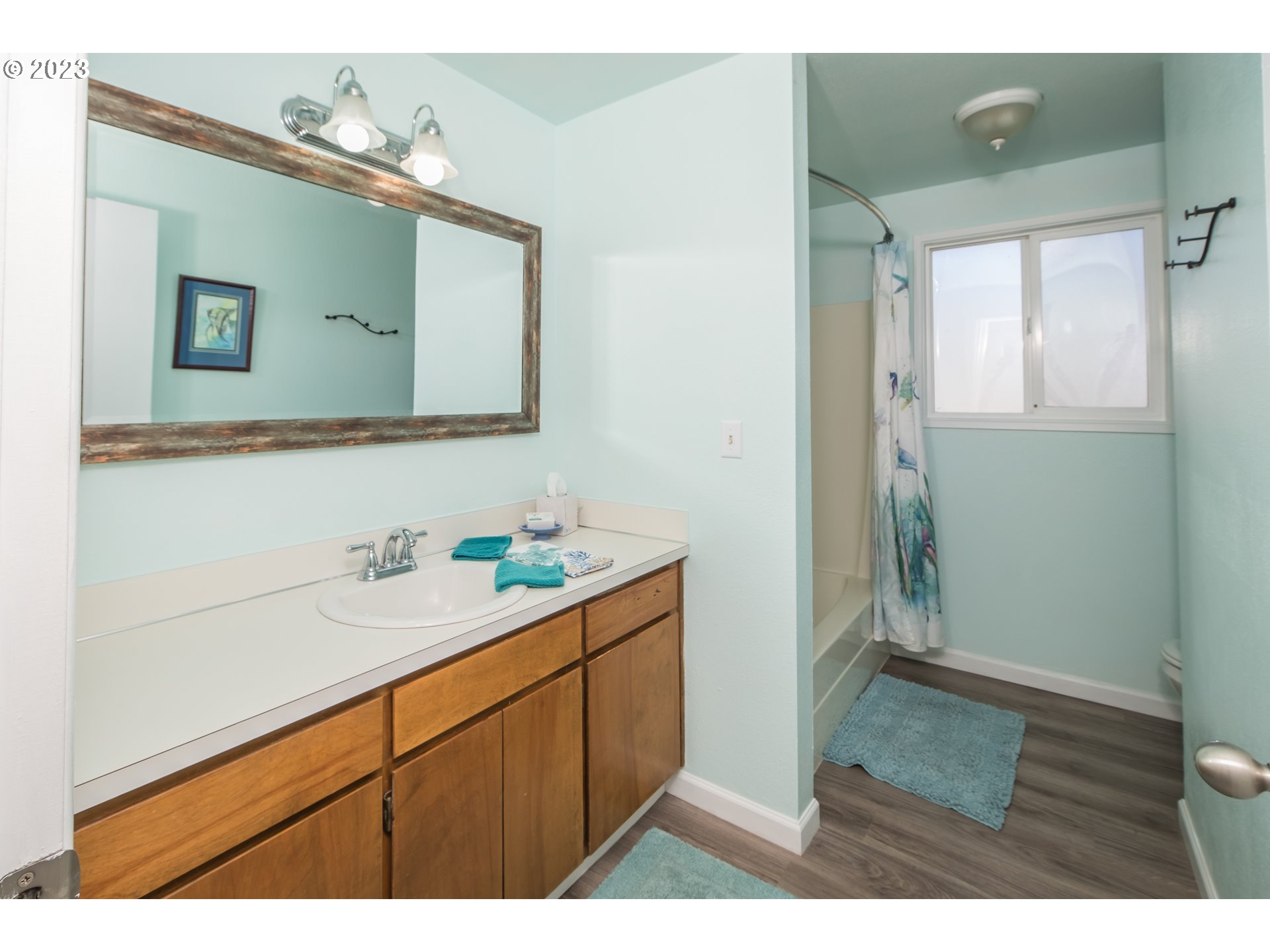 2035 16th Street Florence, OR 97439 - Photo 15 of 30 a bathroom with a sink mirror and vanity