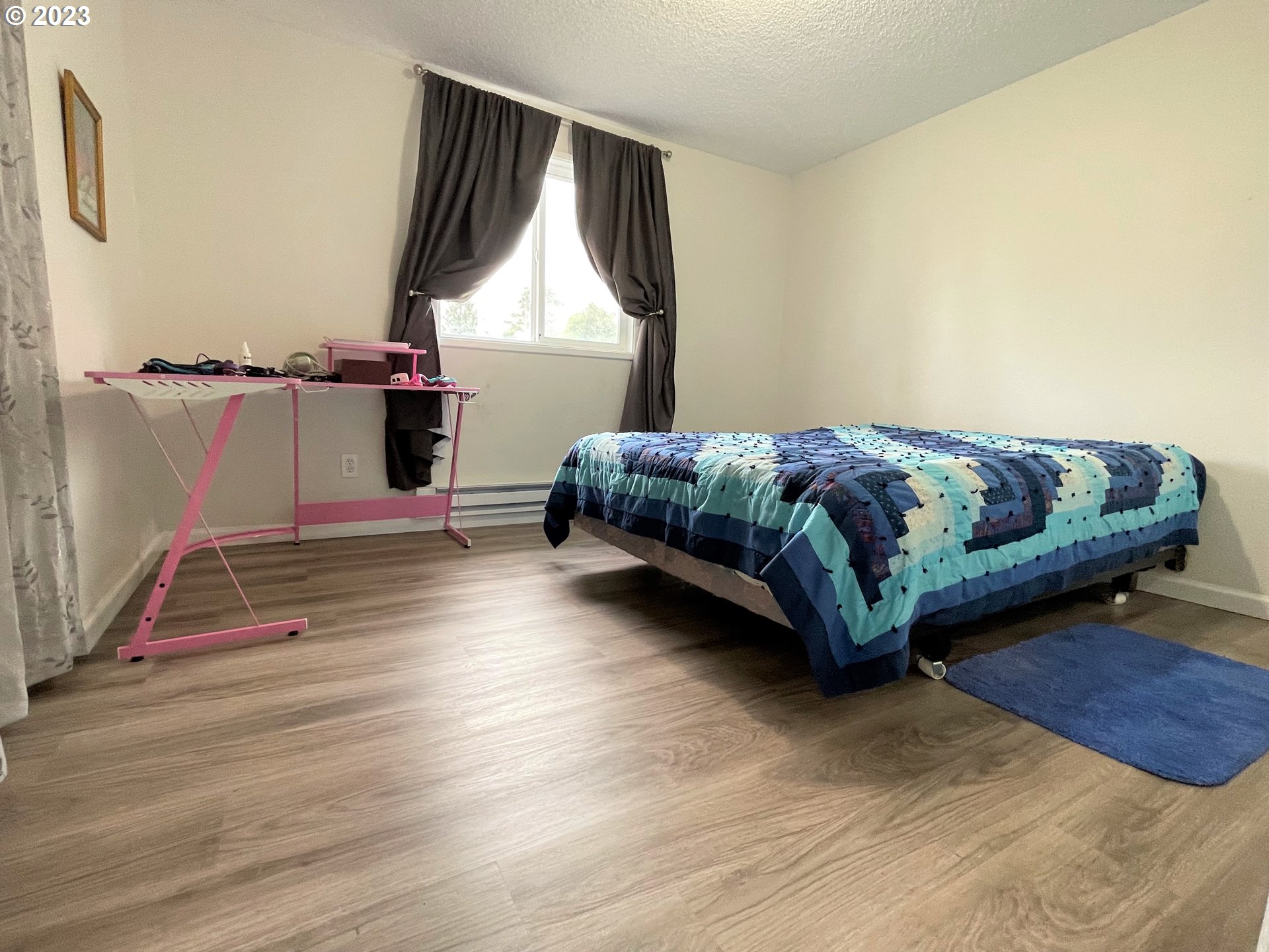 2035 16th Street Florence, OR 97439 - Photo 16 of 30 a bedroom with a bed and window
