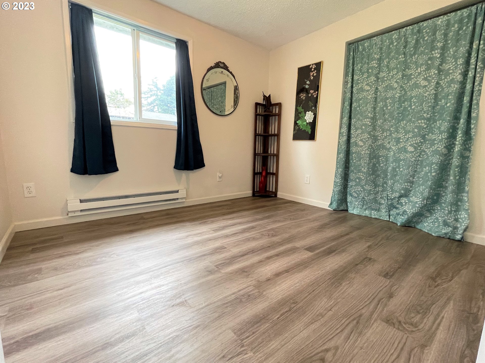 2035 16th Street Florence, OR 97439 - Photo 17 of 30 a view of a closet with wooden floor and windows