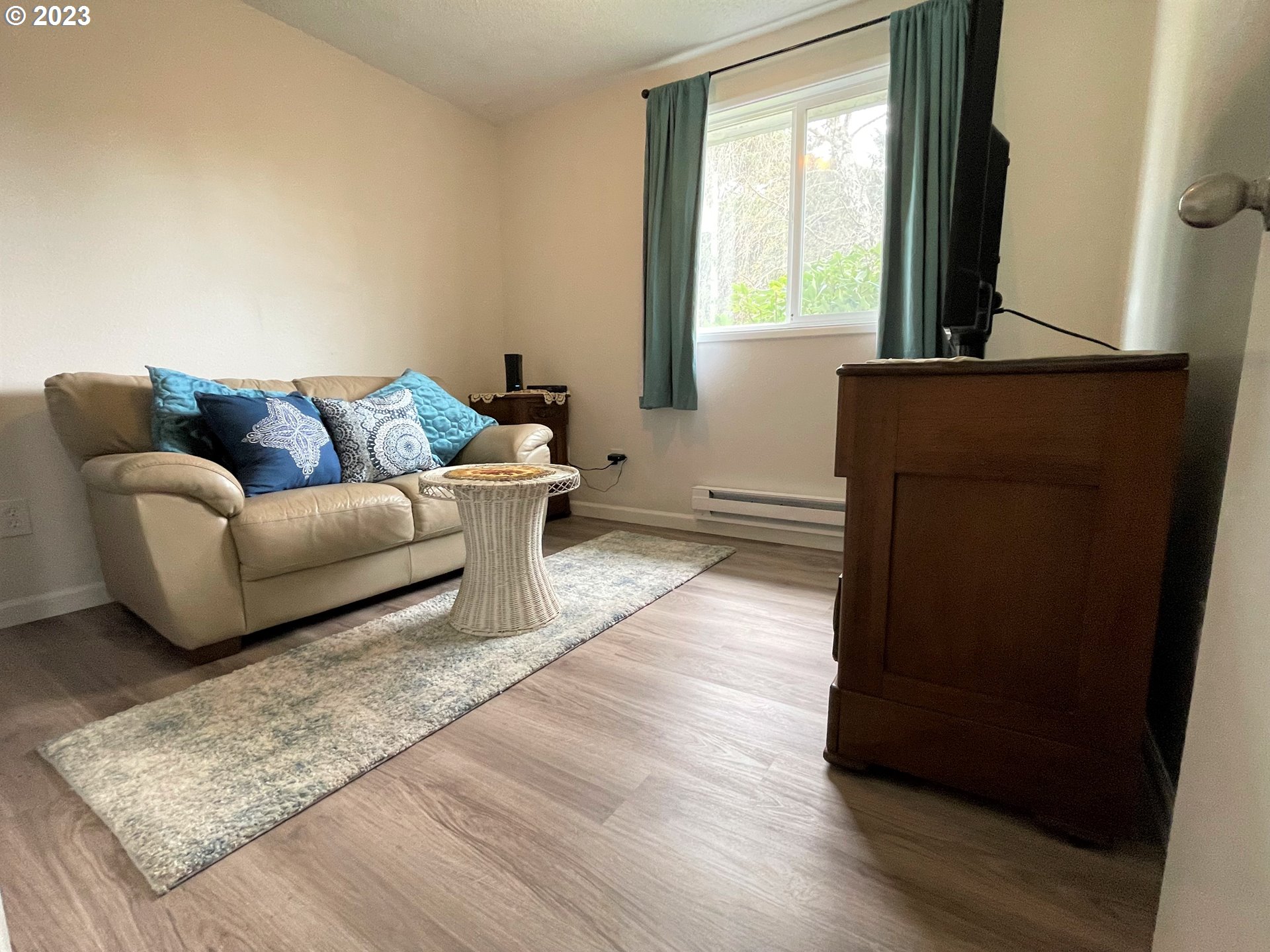 2035 16th Street Florence, OR 97439 - Photo 18 of 30 a living room with a couch and a window