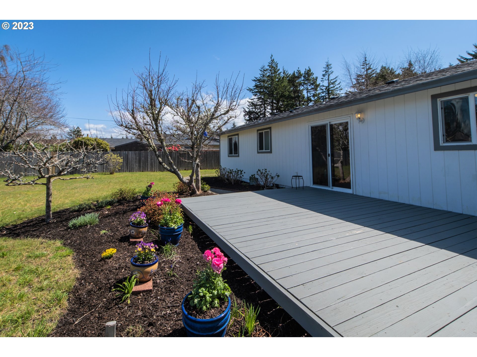 2035 16th Street Florence, OR 97439 - Photo 2 of 30 a view of a backyard with potted plants