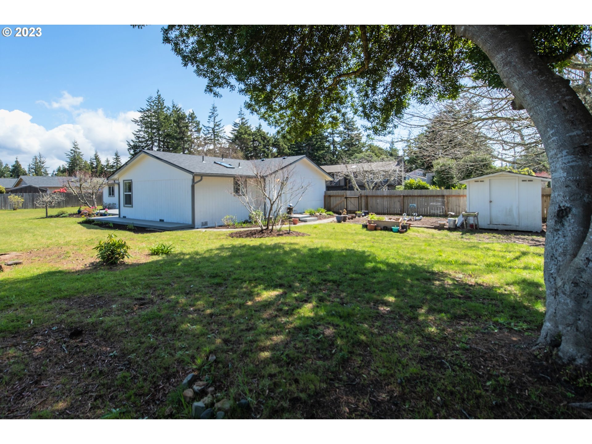 2035 16th Street Florence, OR 97439 - Photo 23 of 30 a view of a house with a yard and sitting area