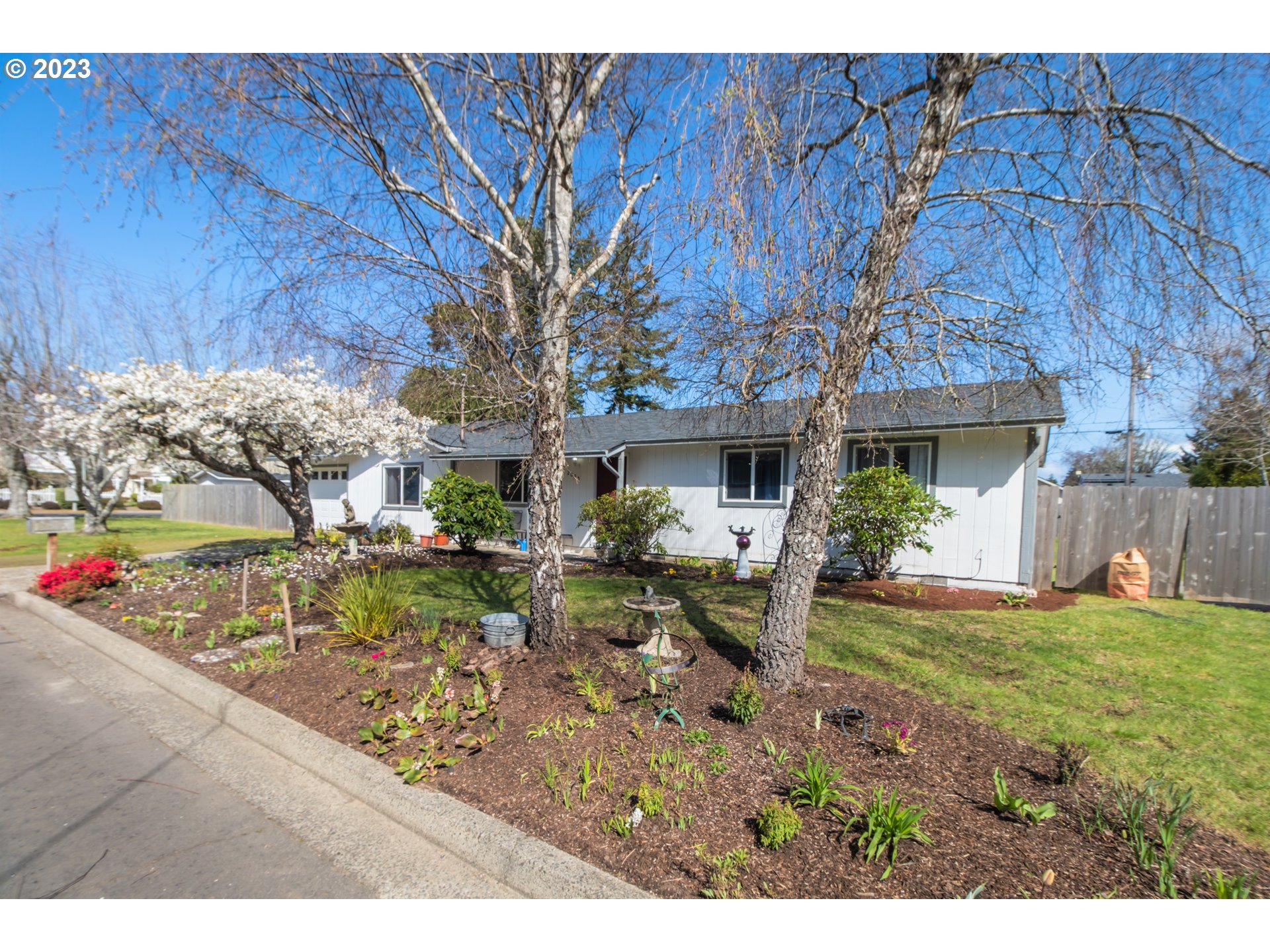 2035 16th Street Florence, OR 97439 - Photo 28 of 30 a view of a house with backyard and sitting area