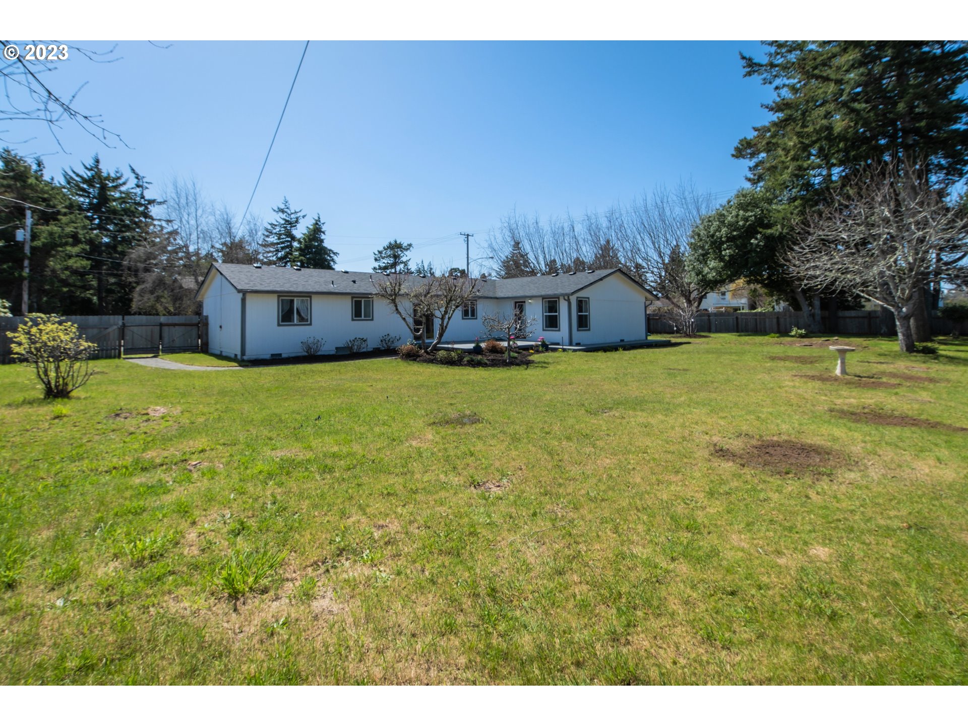 2035 16th Street Florence, OR 97439 - Photo 29 of 30 a view of a house with a yard and sitting area