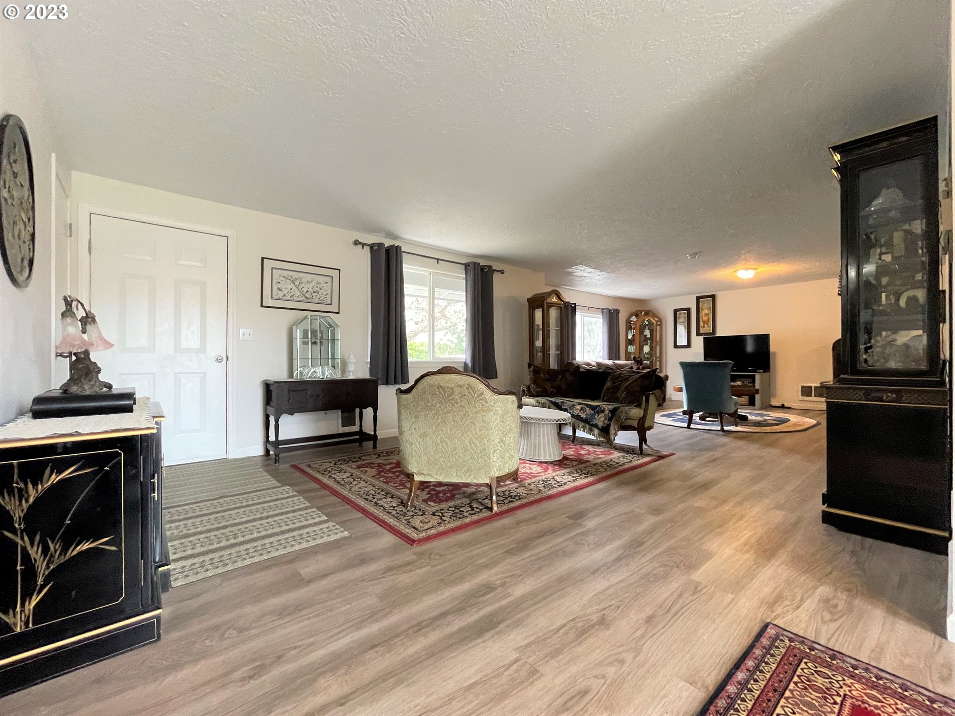 2035 16th Street Florence, OR 97439 - Photo 4 of 30 a living room with furniture a fireplace and a flat screen tv