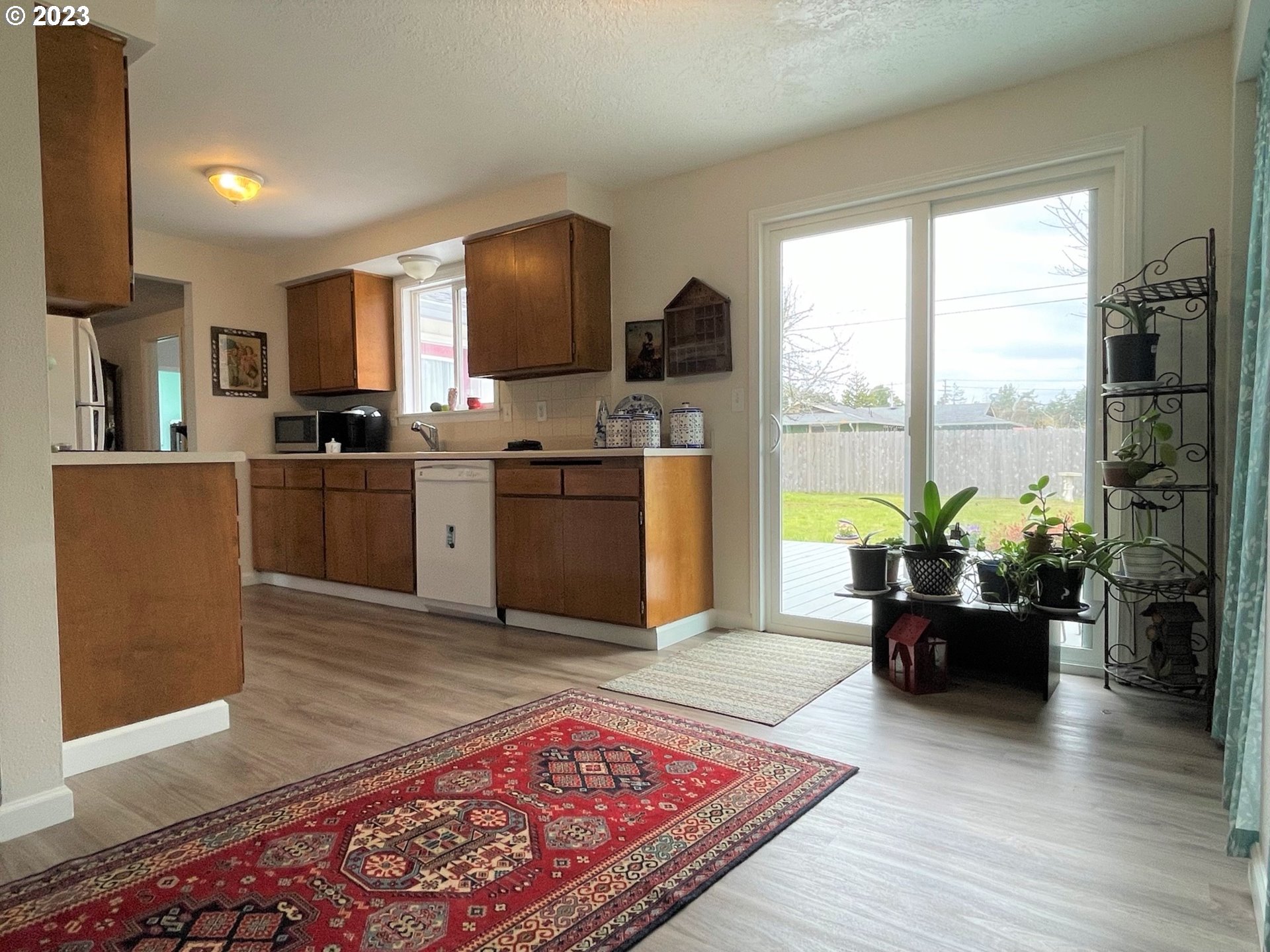 2035 16th Street Florence, OR 97439 - Photo 8 of 30 a living room with stainless steel appliances furniture wooden floor and a view of kitchen
