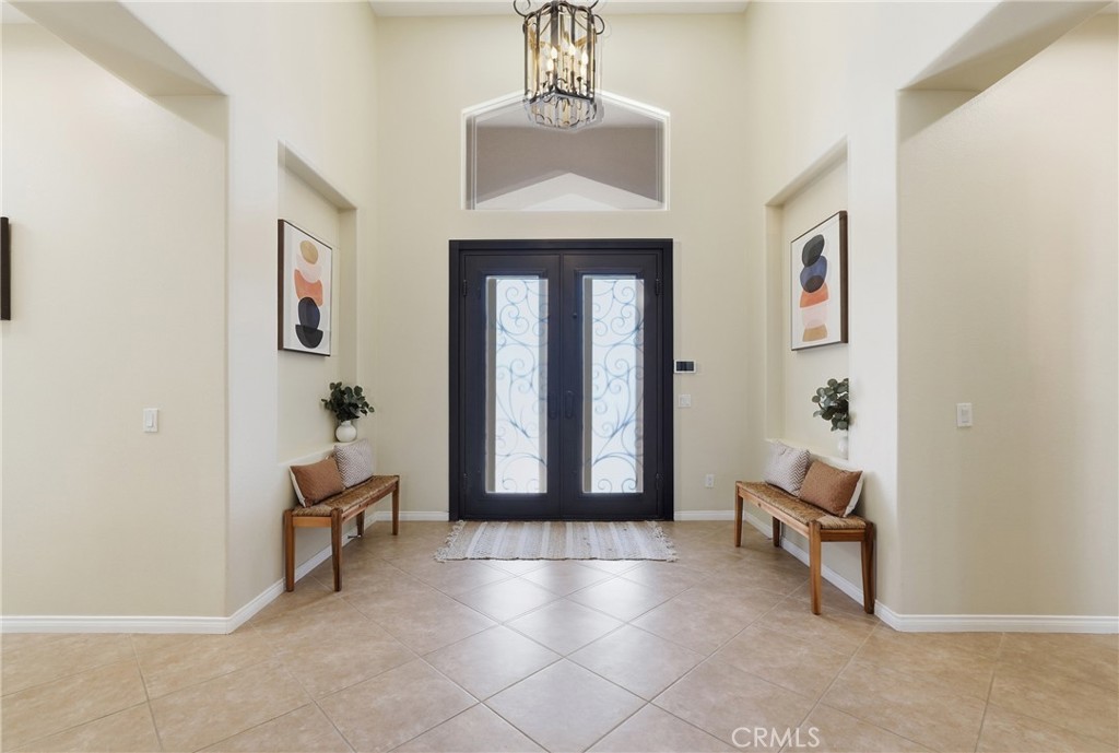 9 Orleans Road Rancho Mirage, CA 92270 - Photo 11 of 71 a view of a hallway with entryway wooden floor and windows