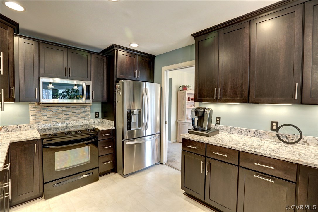 13708 Sandy Oak Road Chester, VA 23831 - Photo 10 of 32 a kitchen with granite countertop stainless steel appliances and refrigerator