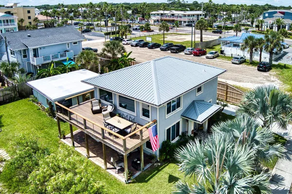an aerial view of a house with a garden and trees